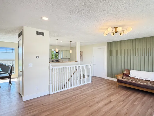 Open concept living area with wood-finish flooring