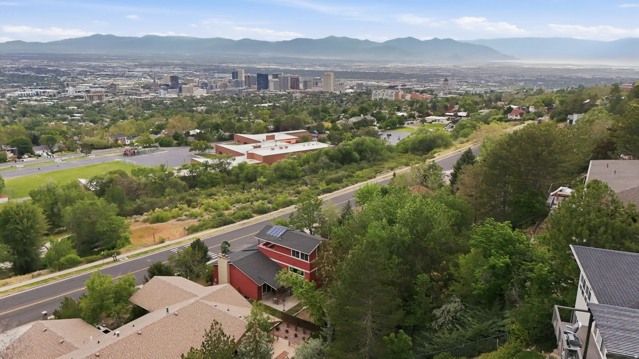 Aerial perspective showcasing a residential property with solar panels on the roof
