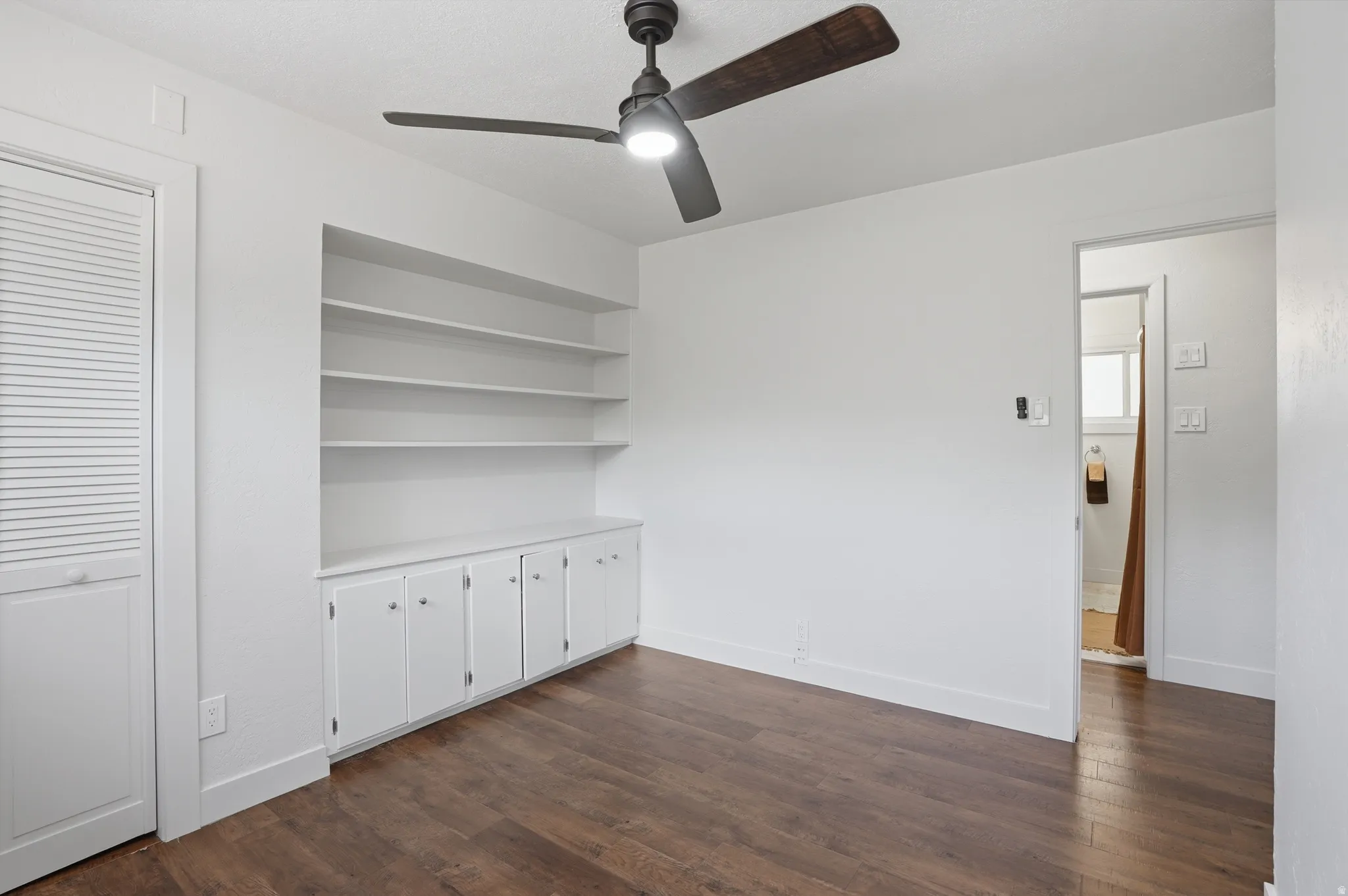 Bedroom 1 with Built-in shelving and cabinetry.