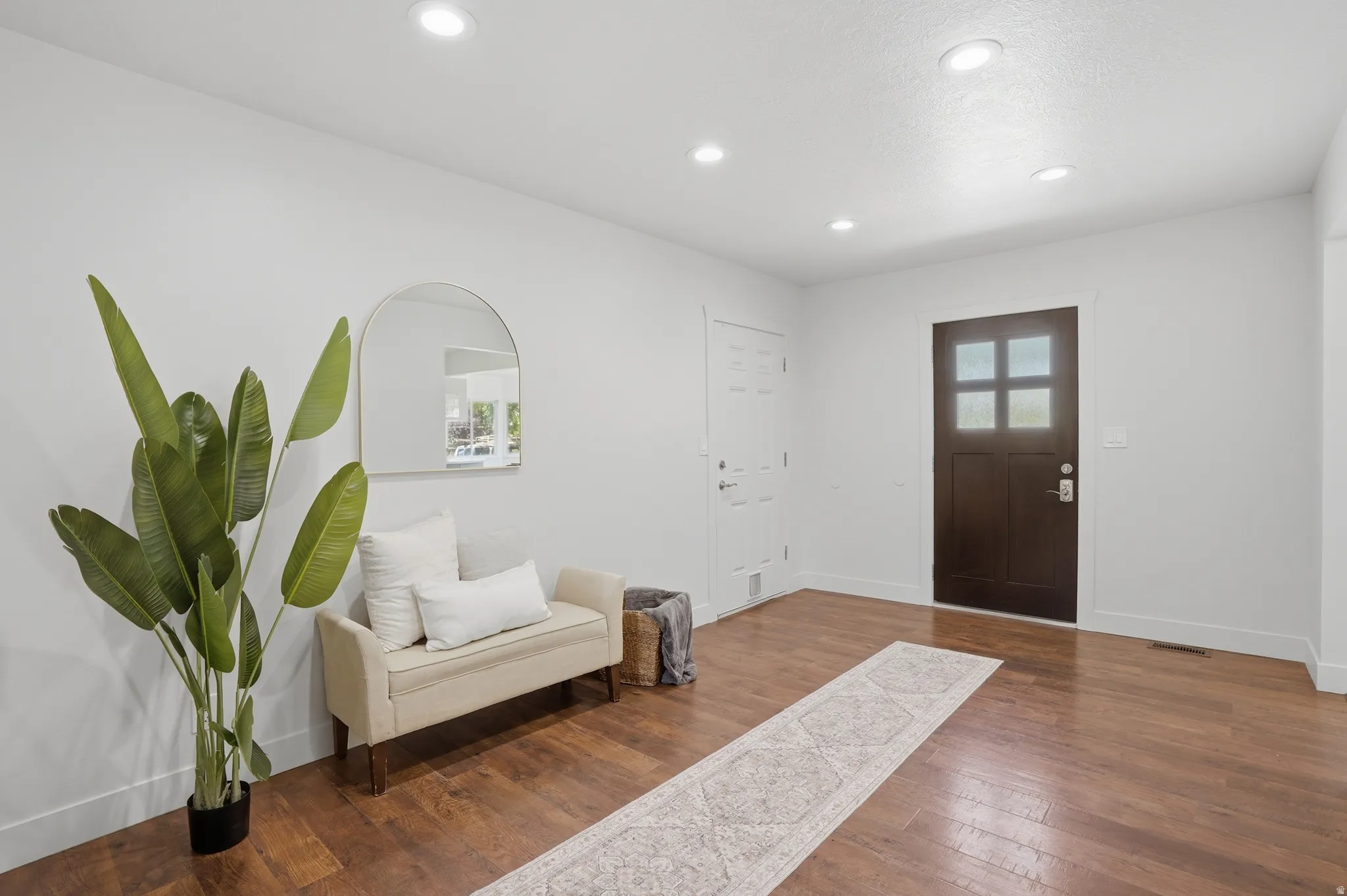 Open concept interior featuring dark wood-finish flooring, recessed lighting, could be used as a den.