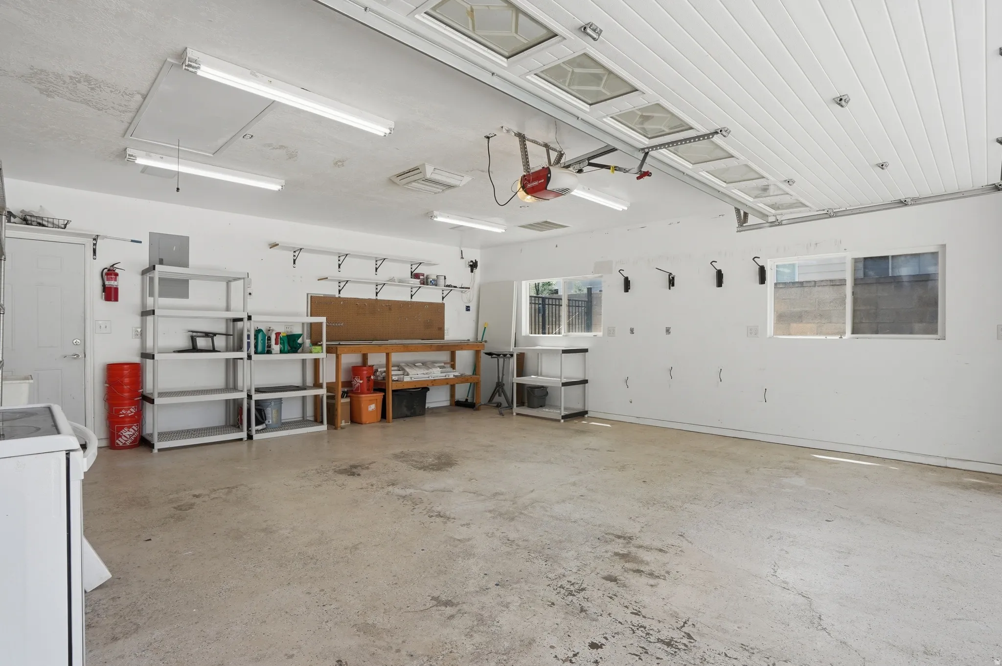 Spacious garage featuring EV hookups, separate heating and cooling, plus a large workbench
