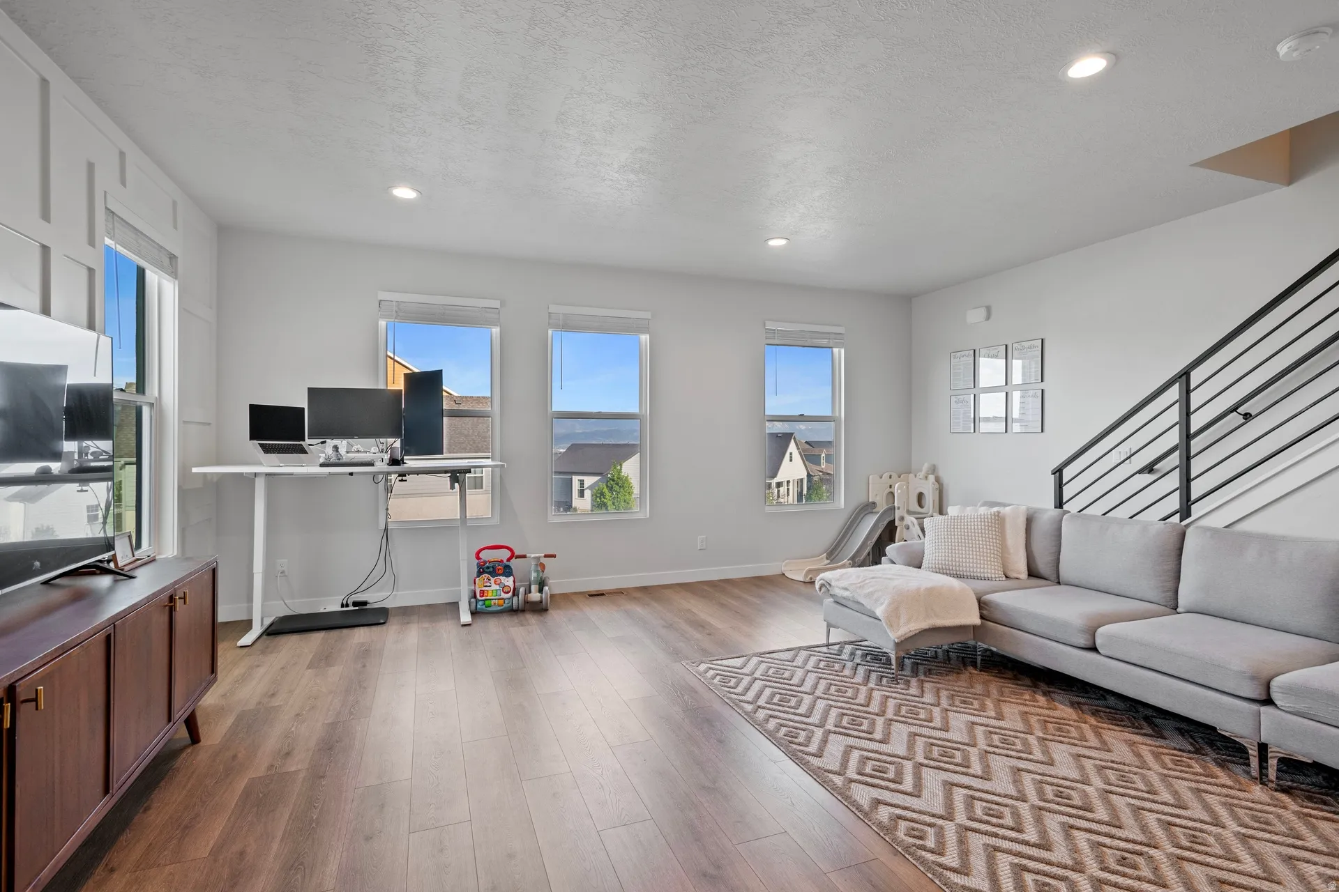 Open concept living area featuring wood-finish flooring