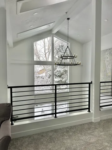 Vaulted ceiling featuring skylights, exposed beams, and recessed lighting