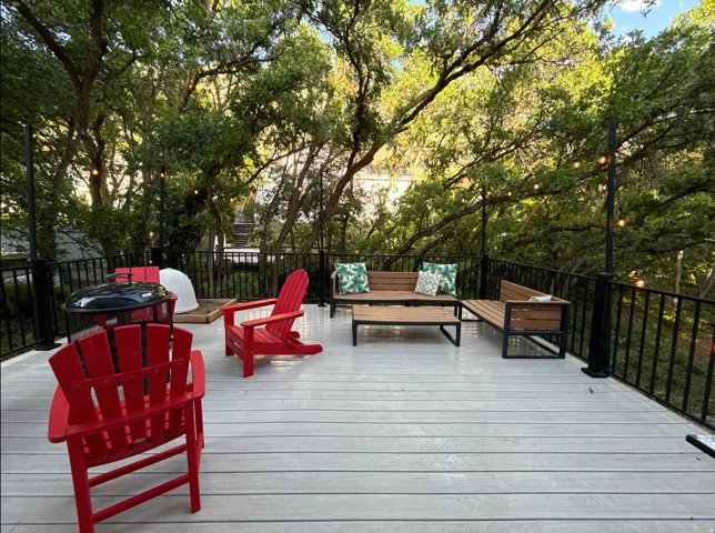 Spacious lower east deck featuring composite decking and black metal railings