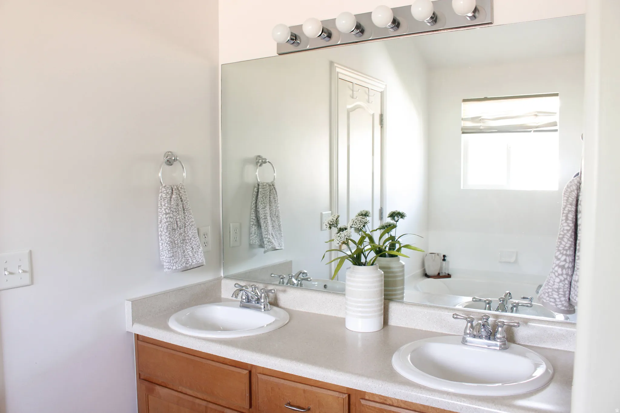 Primary bathroom featuring double vanity. Light and bright!