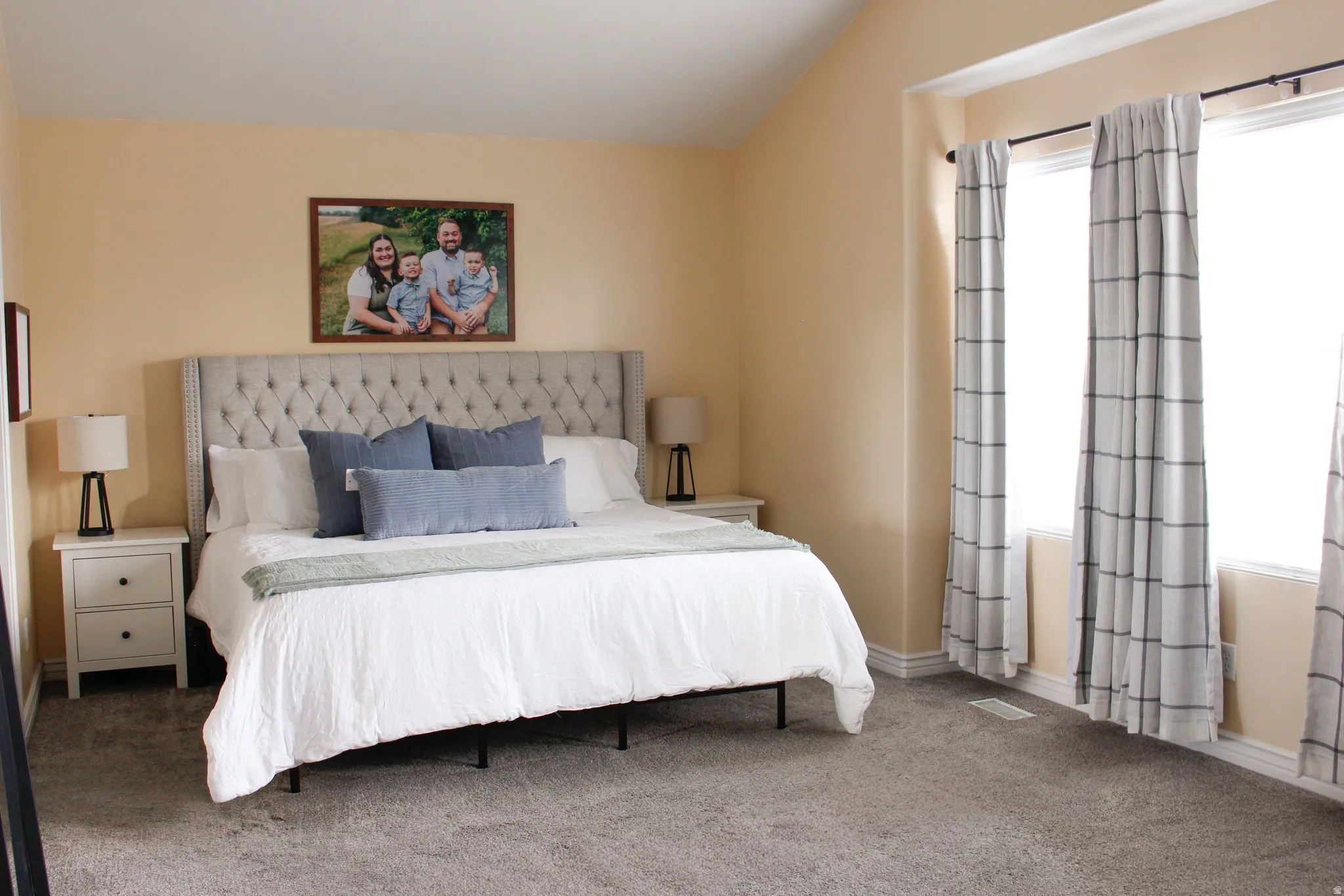 Oversized primary bedroom featuring tons of natural light. Sky high vaulted ceilings.