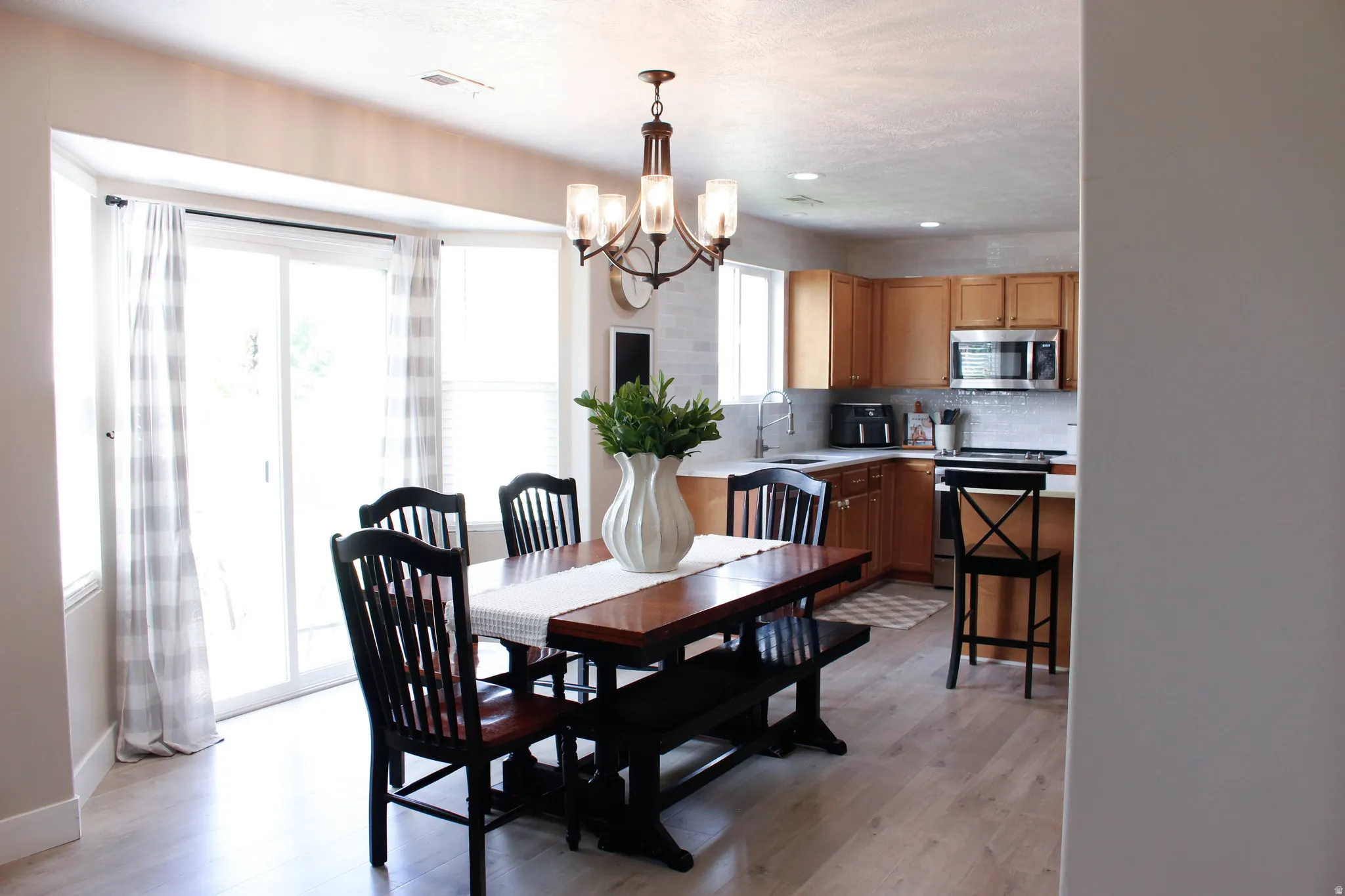 Dining area with beautiful lighting and access to the backyard.