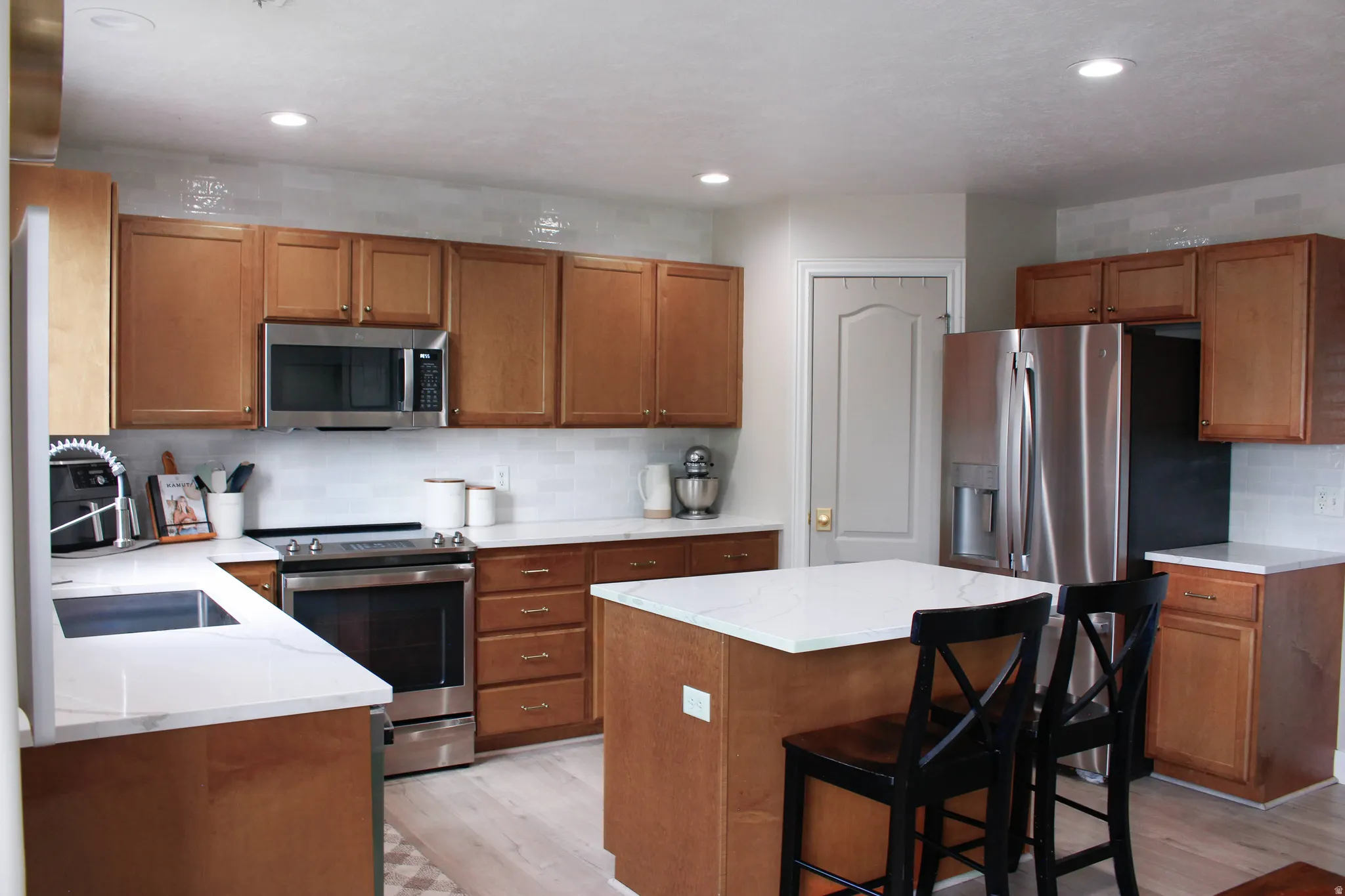 Check out this updated kitchen! The pictures do not do it justice! Extra cabinet lighting, subway tile backsplash, Quartz countertops.