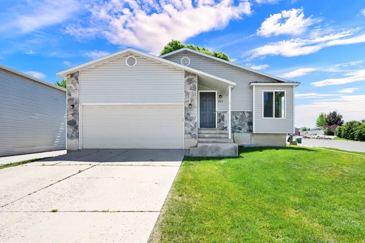 Ranch-style exterior featuring light-colored siding and stone accents
