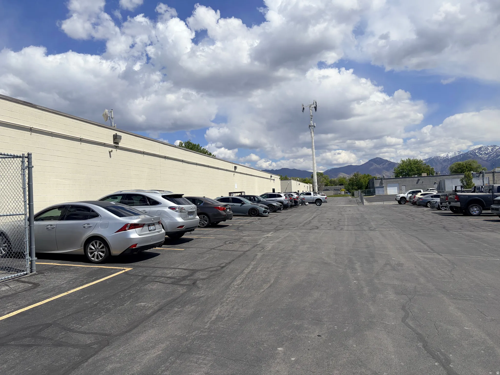 Expansive asphalt parking lot with multiple marked spaces
