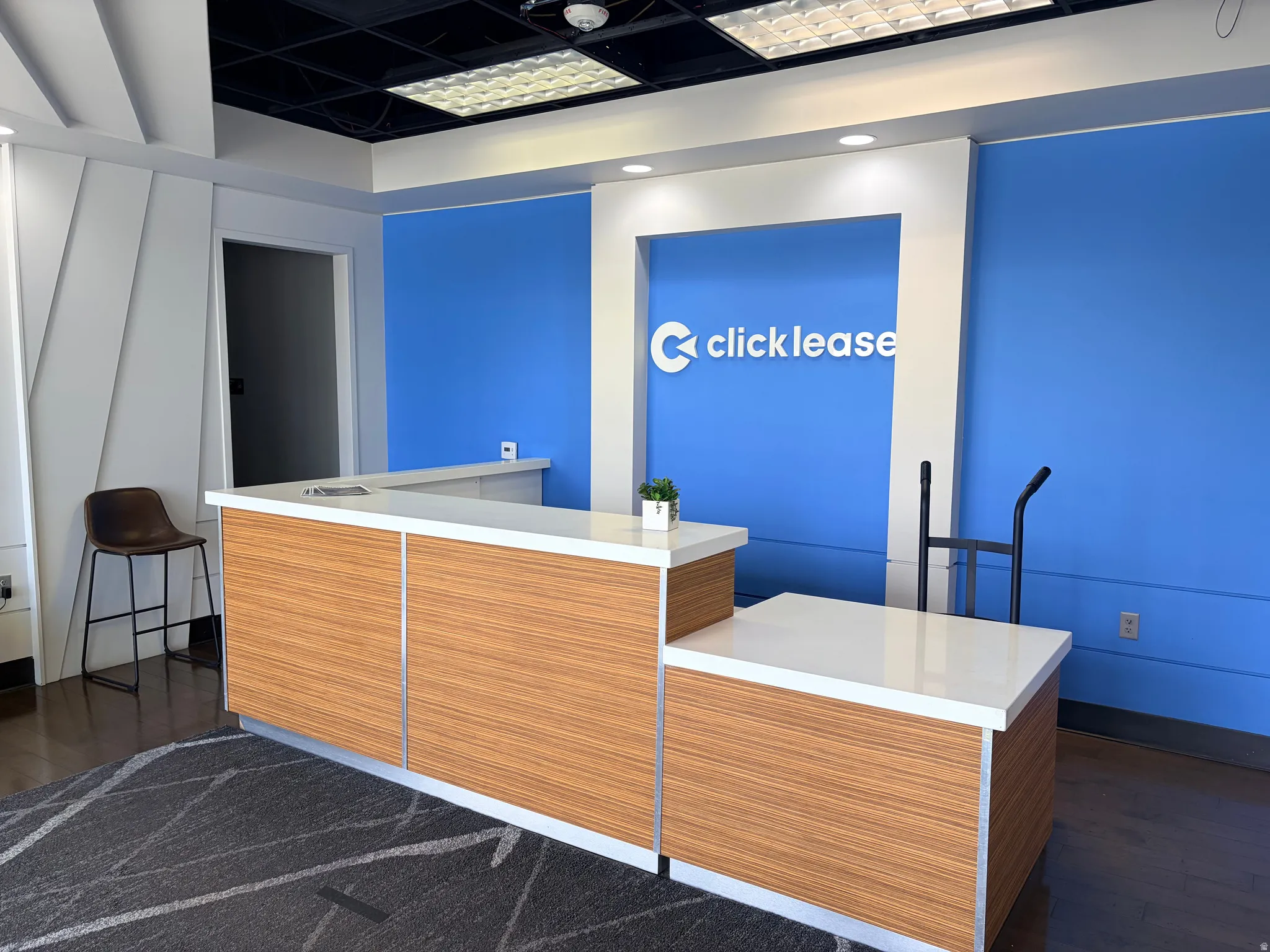 Reception desk featuring wood-finish paneling and a white countertop