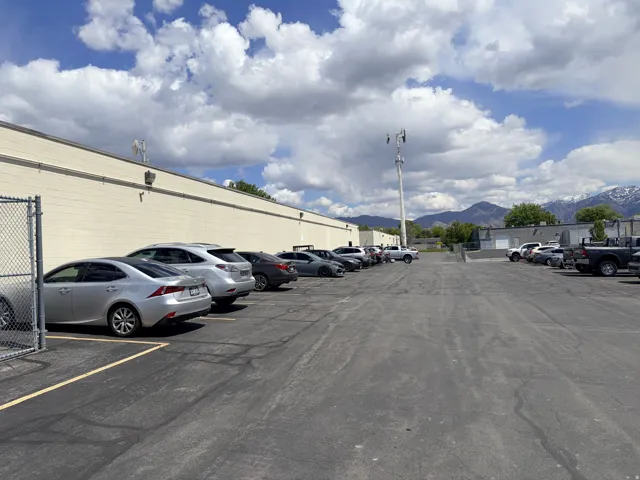 Expansive asphalt parking lot with multiple marked spaces