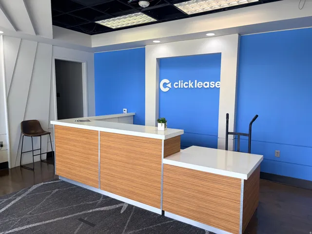 Reception desk featuring wood-finish paneling and a white countertop