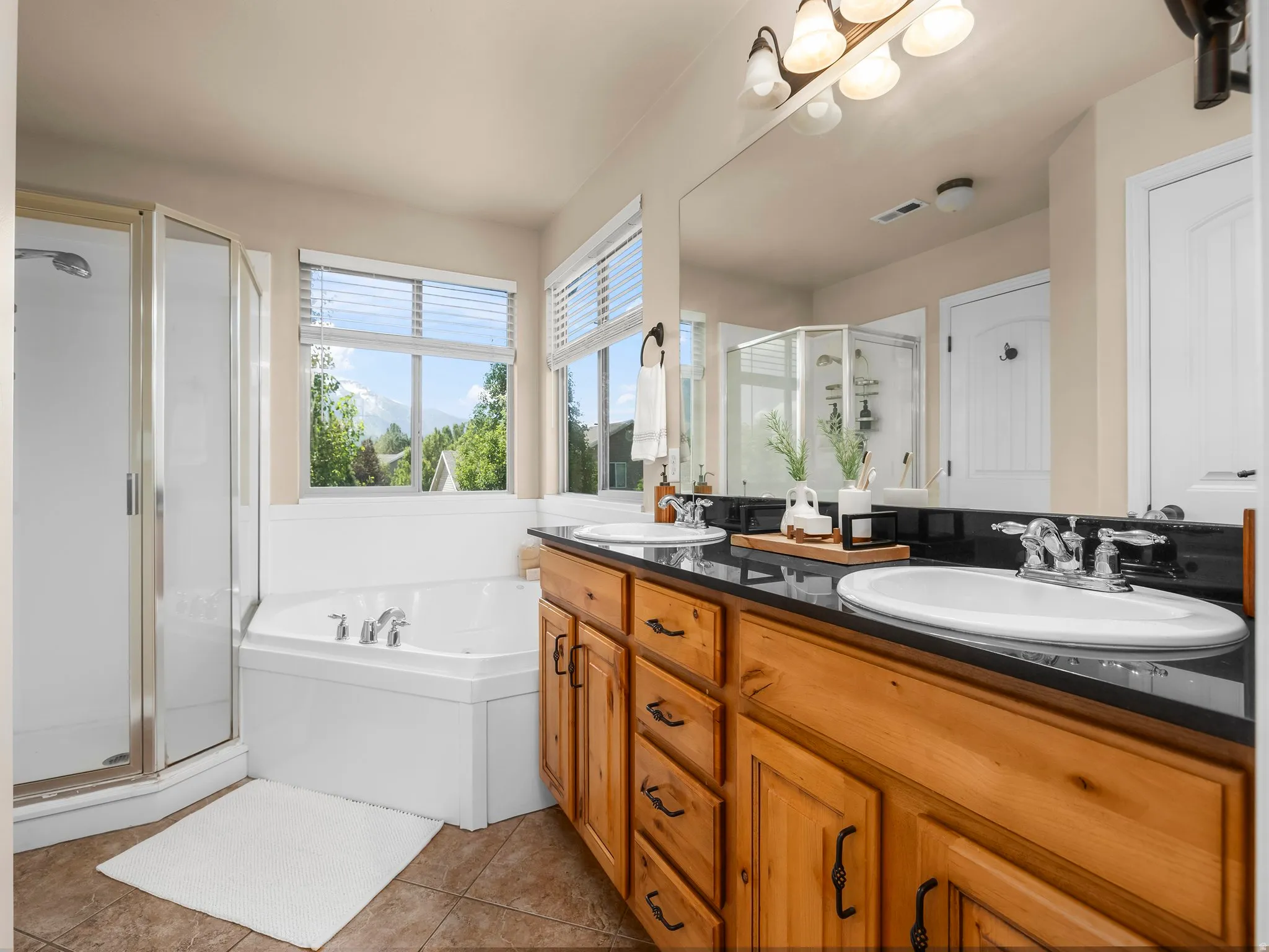 Principal bath with jetted tub and separate shower.