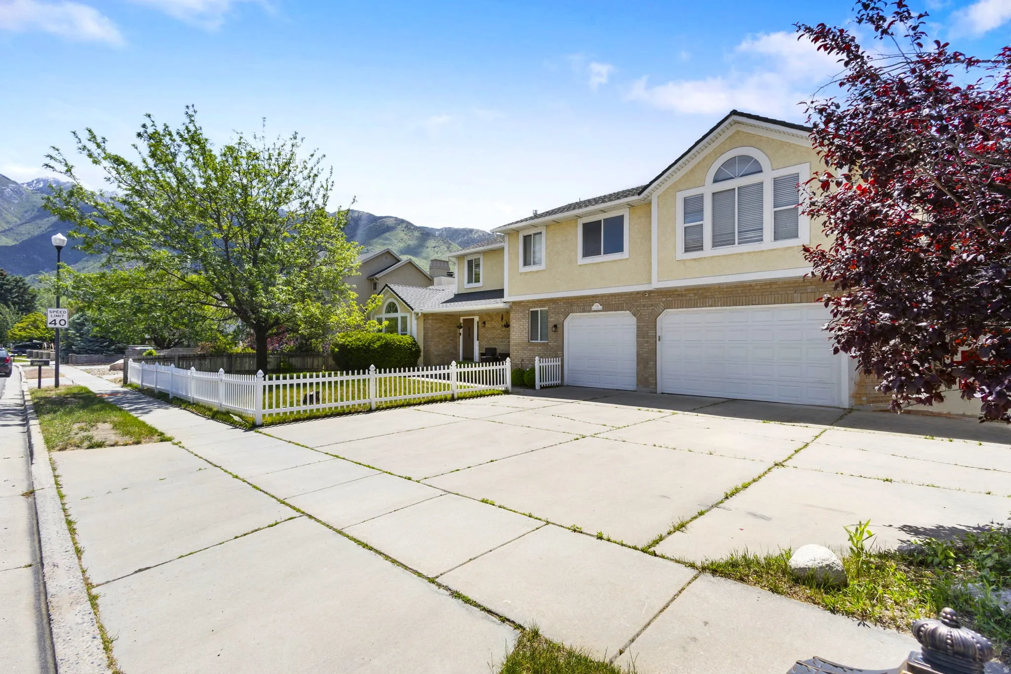Two-story residence featuring a two-car garage and an additional single-car garage