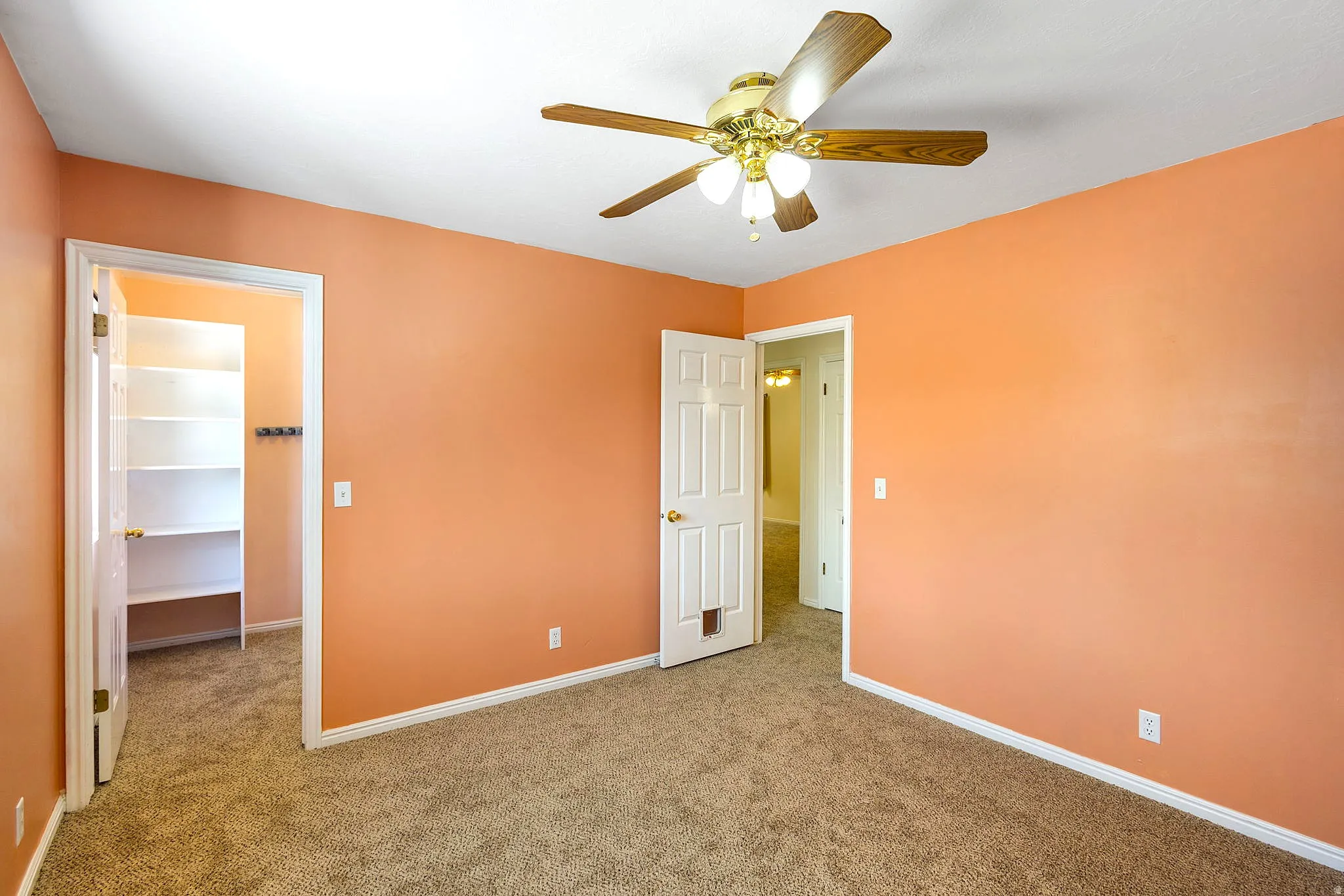Bedroom #3, Carpeted room with orange walls and white trim