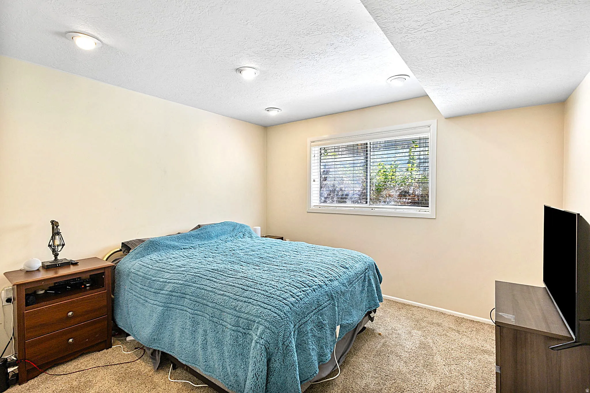 Bedroom #5 featuring recessed lighting, a window with horizontal blinds, light-toned walls, and carpet flooring