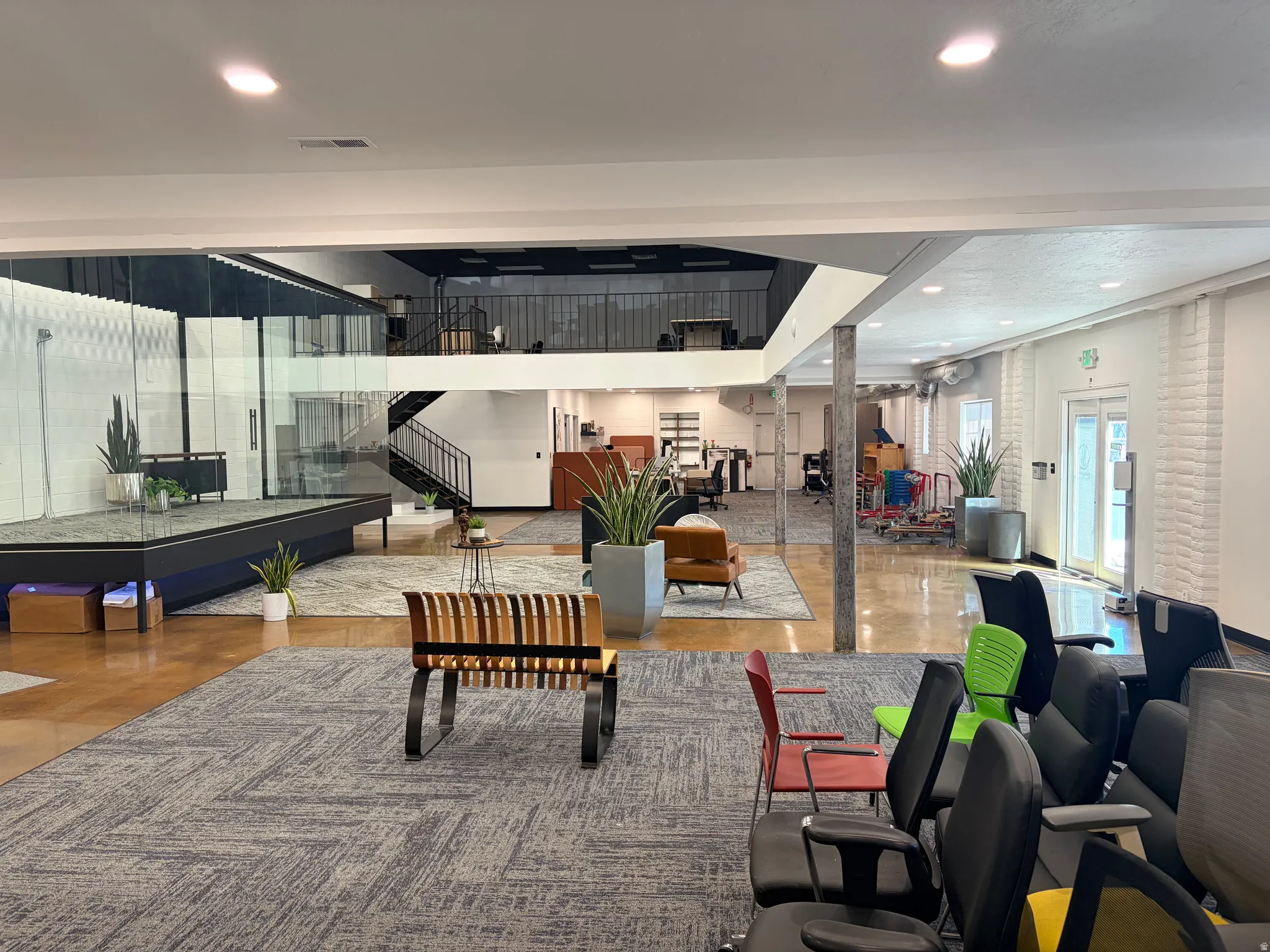 Open-concept commercial space featuring wood-finish flooring, recessed lighting, and a multi-level layout