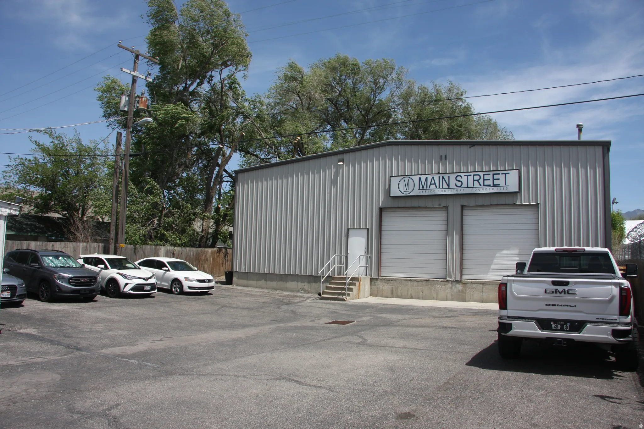Commercial building featuring corrugated metal siding and a prominent exterior sign