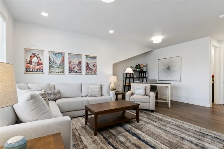 Spacious living area featuring recessed lighting and wood-finish flooring