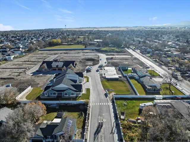 Aerial perspective showcasing residential properties and undeveloped lots