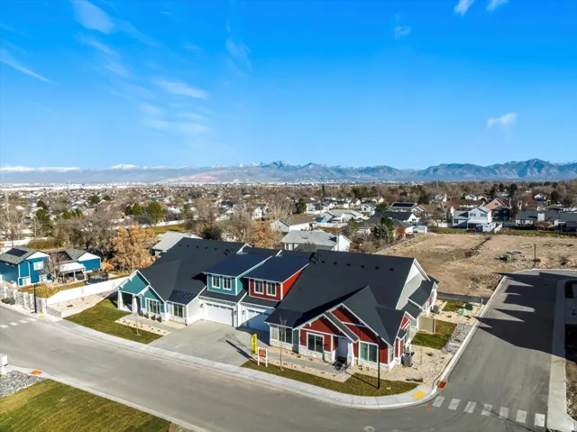 Modern townhome development with multi-colored siding and dark shingle roofs