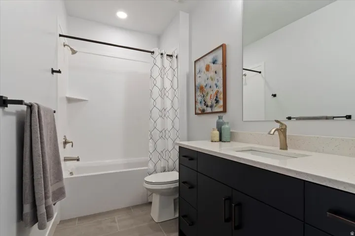 Contemporary bathroom with a dark cabinetry vanity, light-toned countertop, and undermount sink