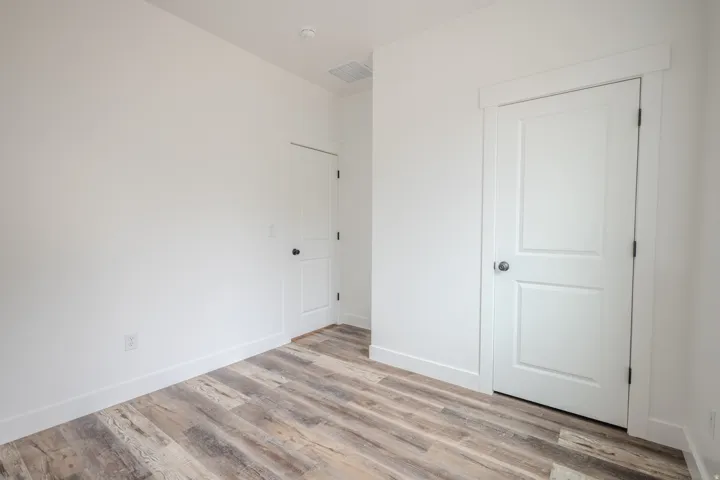 Neutral white walls complement wood-finish flooring