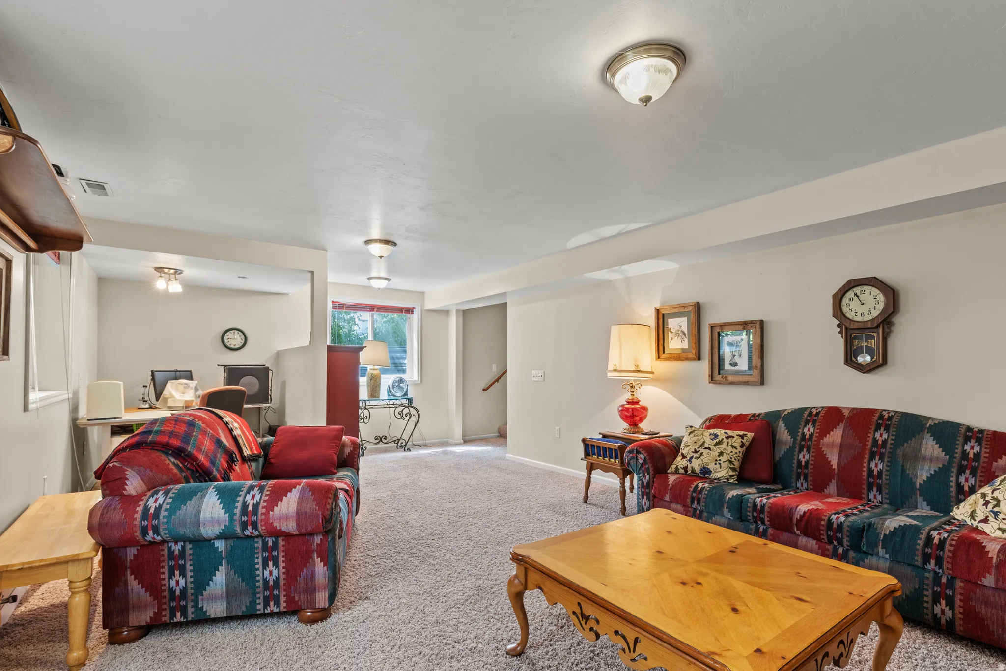 Carpeted recreation area with neutral wall tones