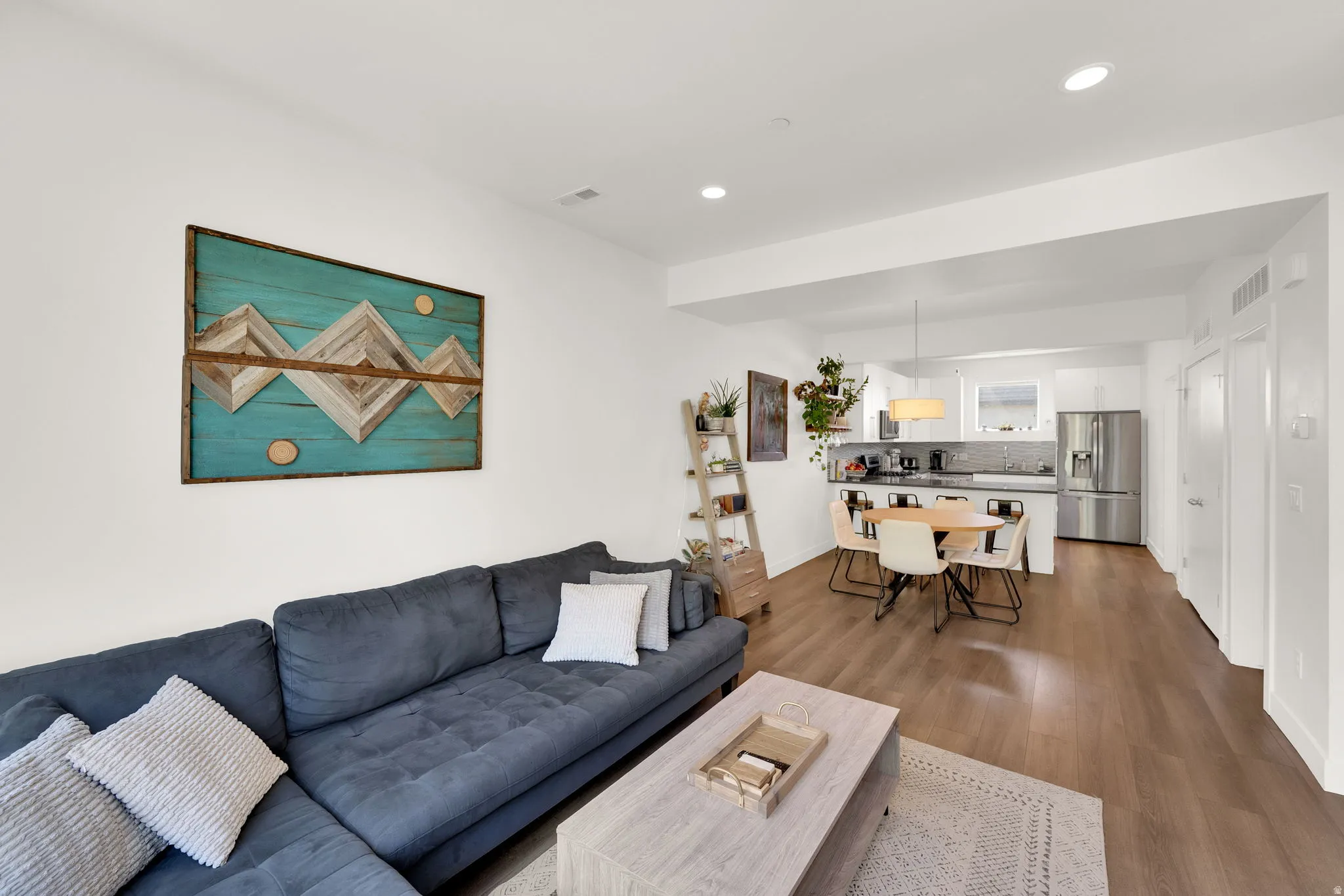 Open-concept living space with wood-finish flooring throughout