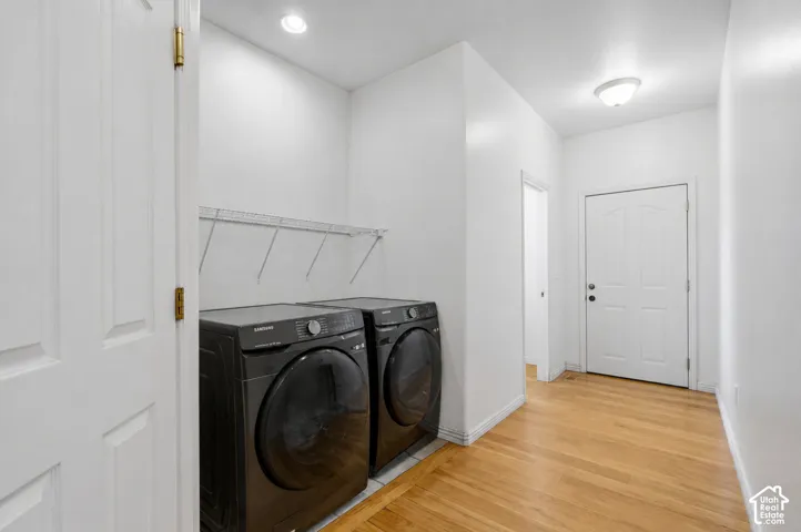 Laundry area featuring wood-finish flooring and wire shelving