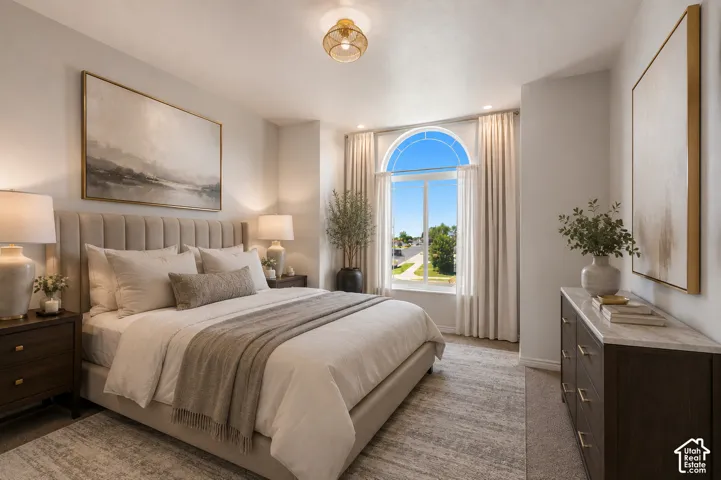 Arched window, recessed lighting, ceiling light fixture, wood-finish nightstands, and a dresser with a stone-finish top