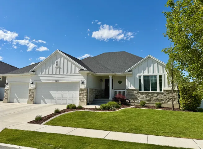 Contemporary ranch-style residence featuring a prominent two-car garage