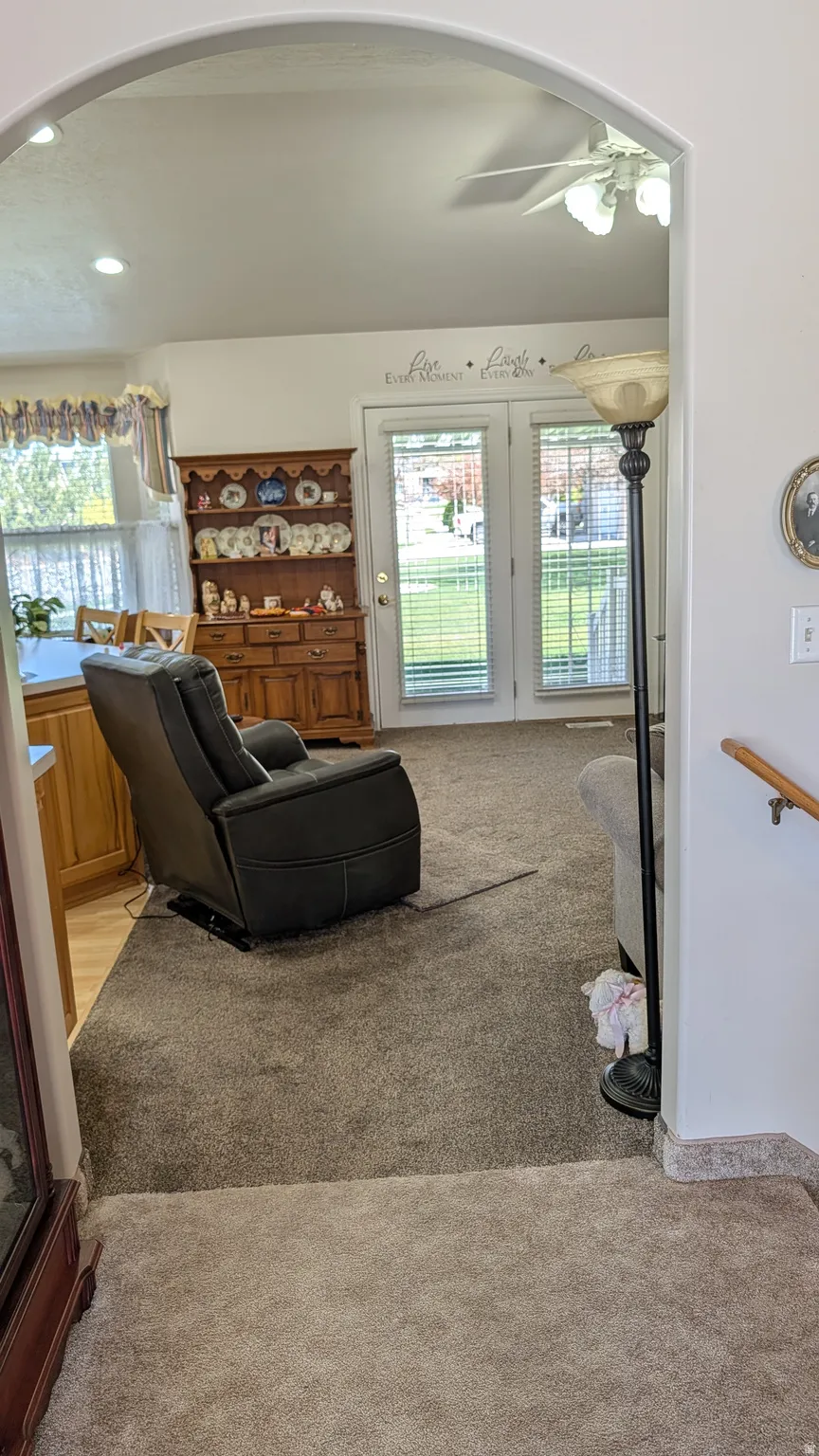 Archway entry framing a living space with plush carpet flooring