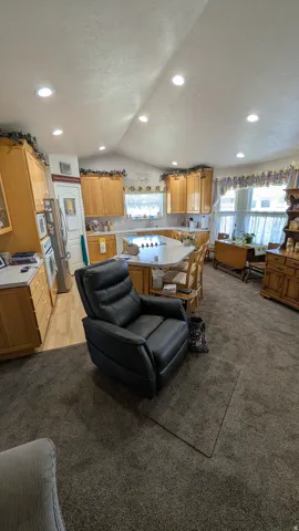 Kitchen featuring light wood cabinetry and a peninsula with seating
