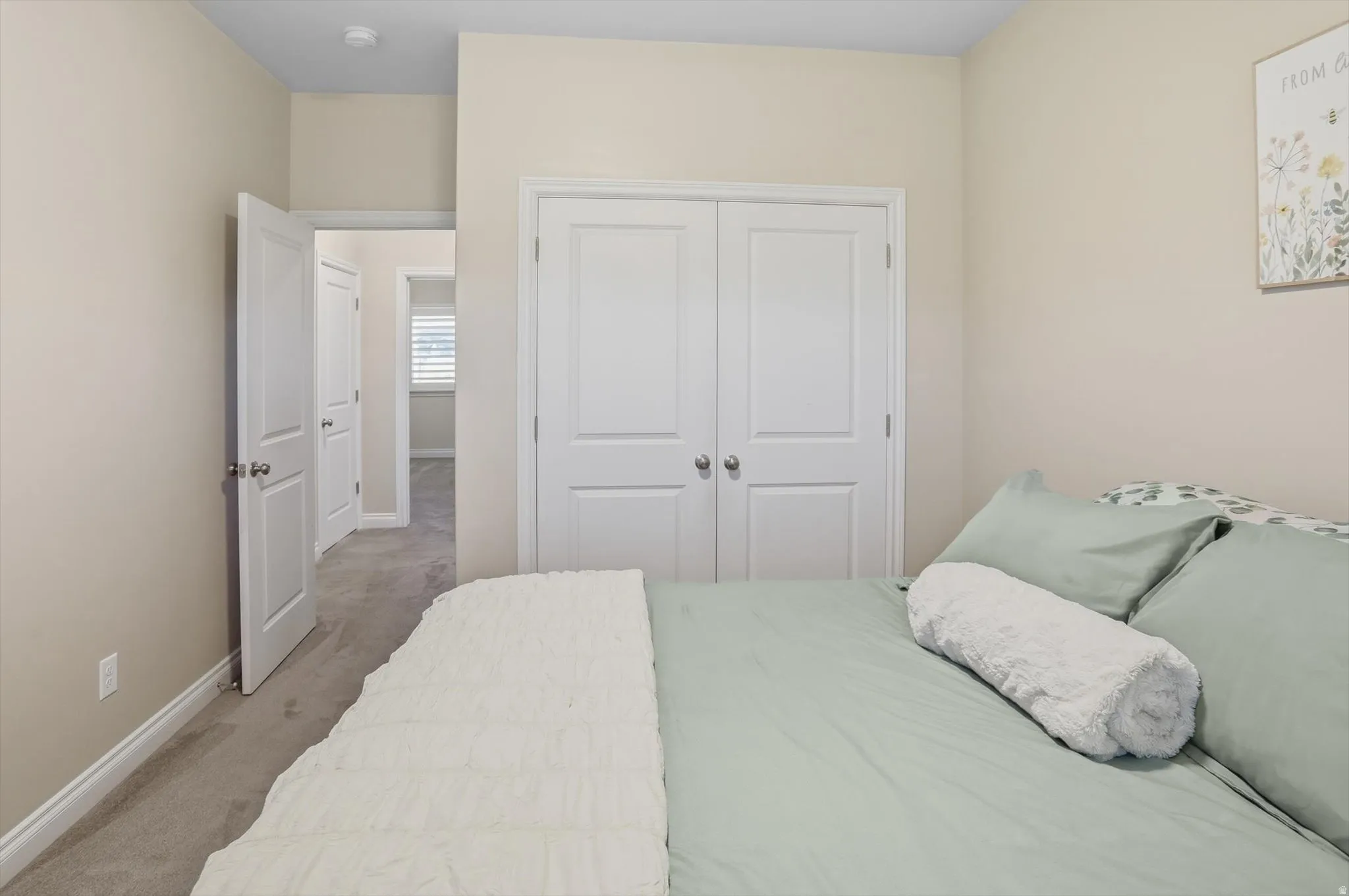 Light-toned walls complement the neutral carpeting
