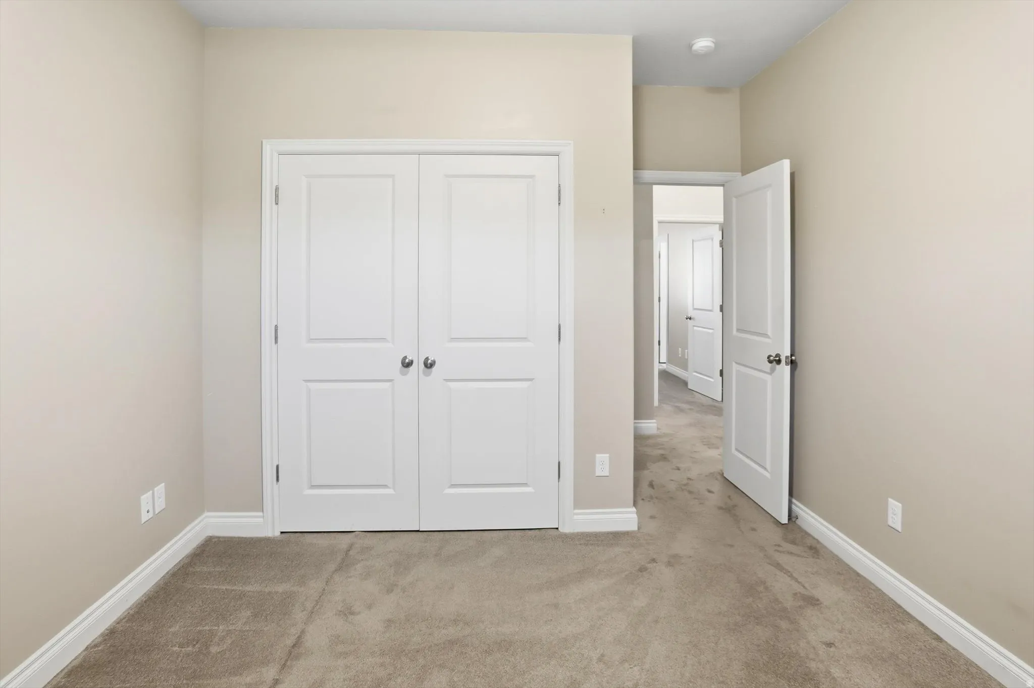 Neutral tone walls with white baseboards and trim