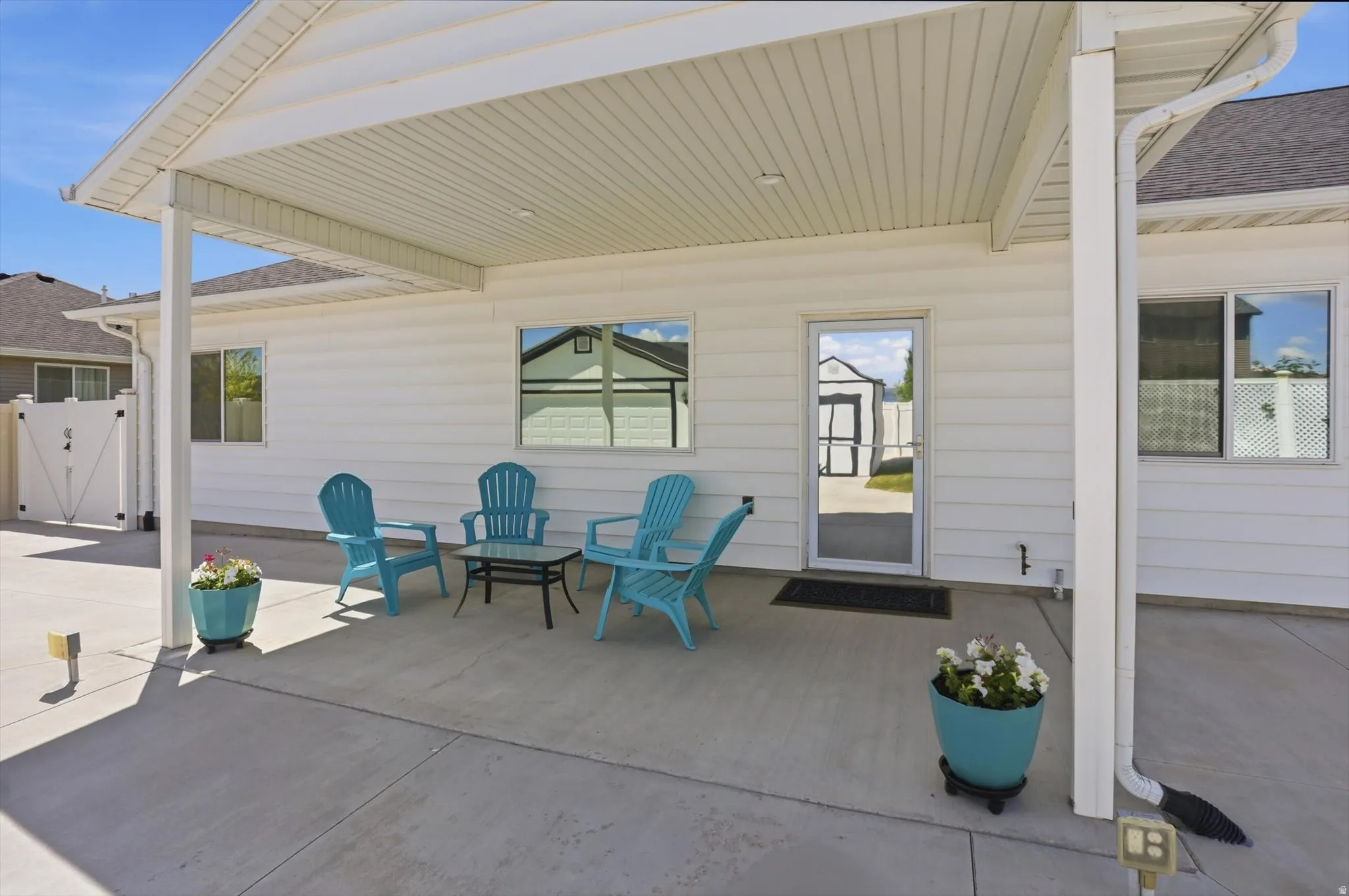 Covered patio featuring concrete flooring and white vinyl siding
