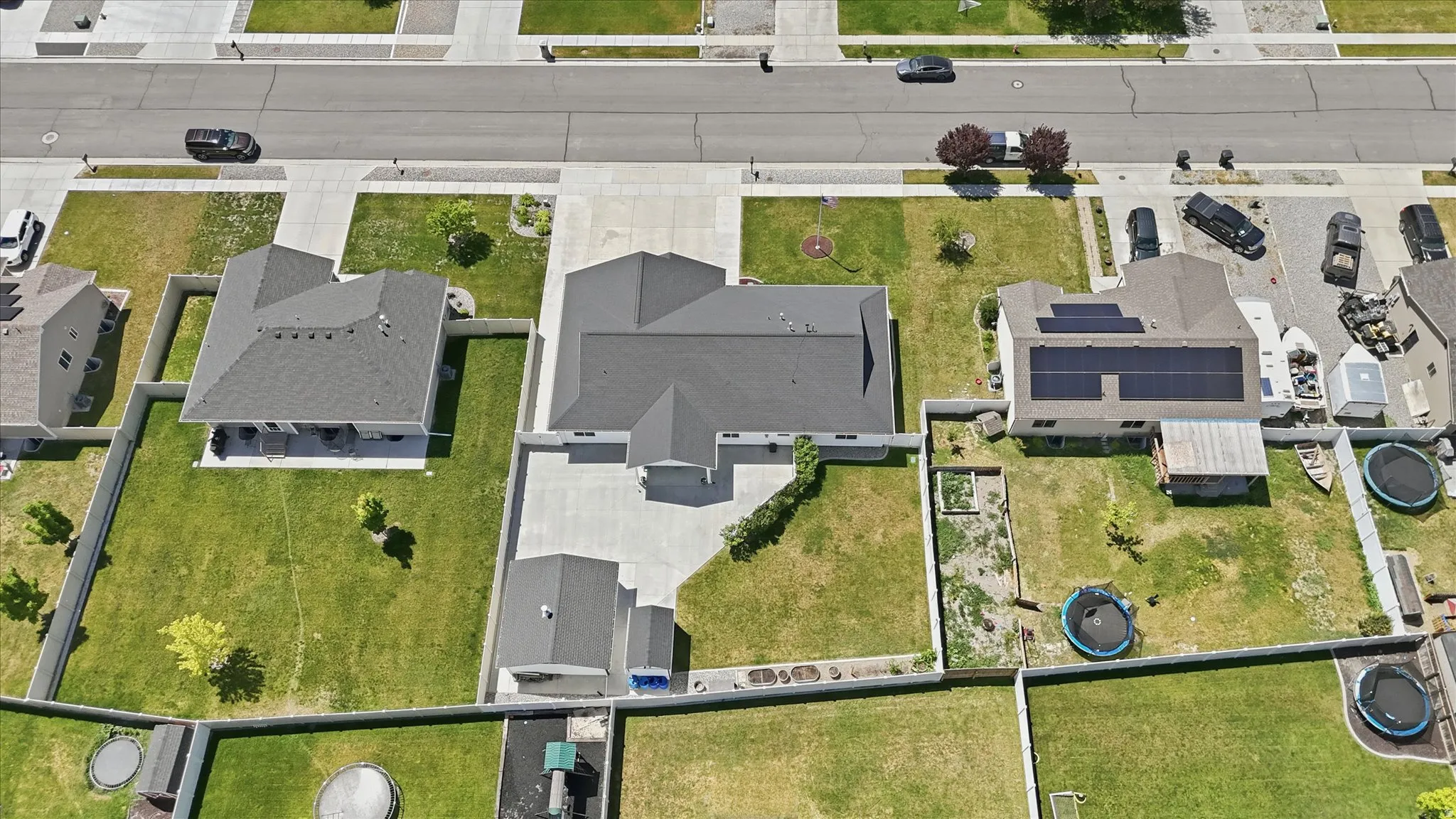 Expansive property featuring a large main residence with a substantial paved driveway and an additional detached structure