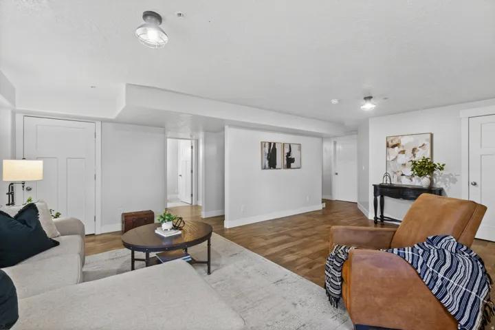 Spacious living area featuring wood-finish flooring, light gray walls, white trim, and recessed lighting