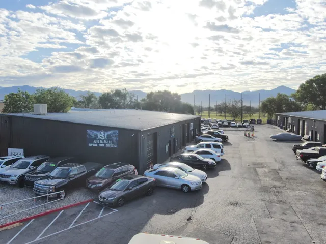Commercial property featuring two industrial buildings with dark siding and flat roofs