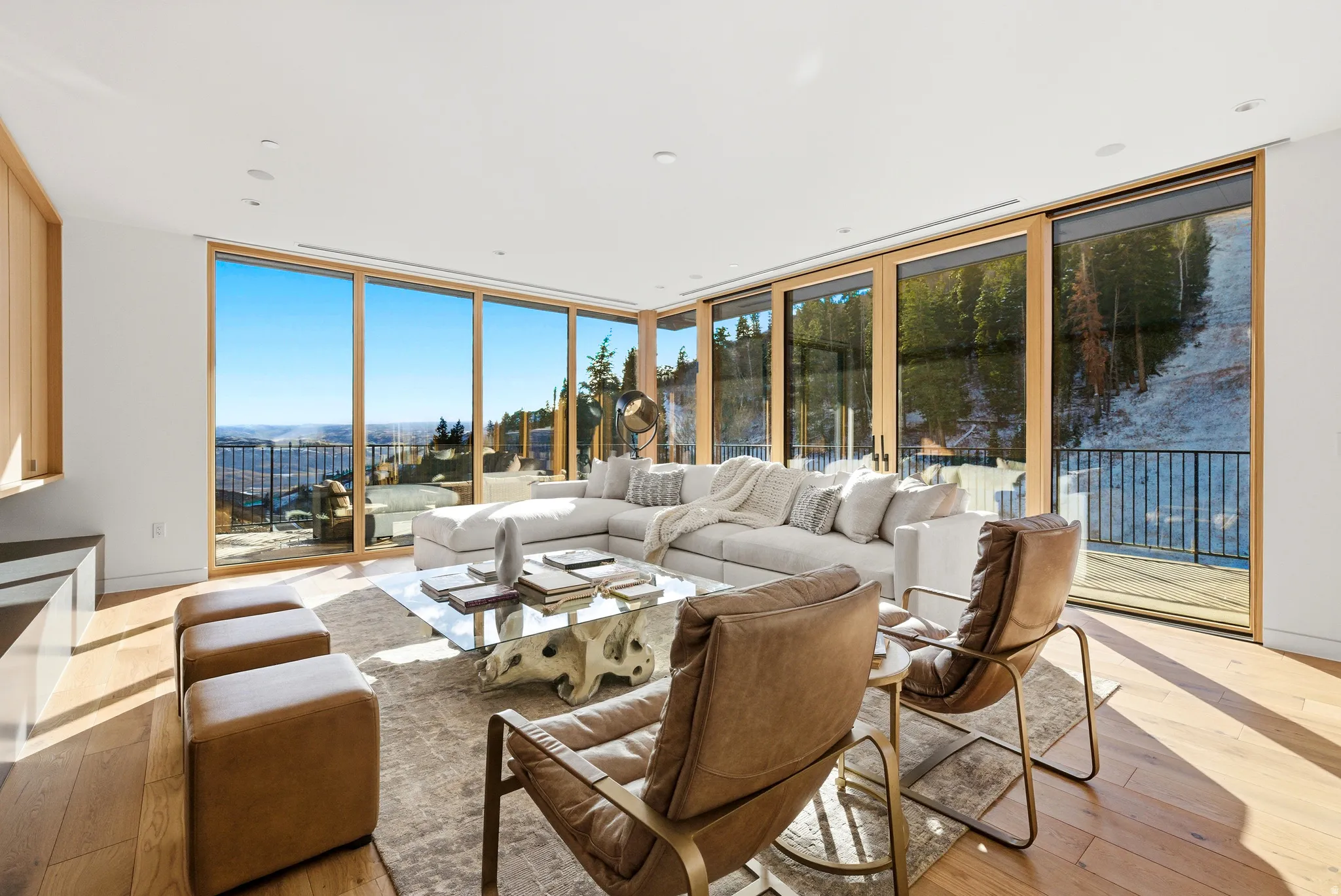 Living space featuring wood-finish flooring and extensive floor-to-ceiling windows with wood frames