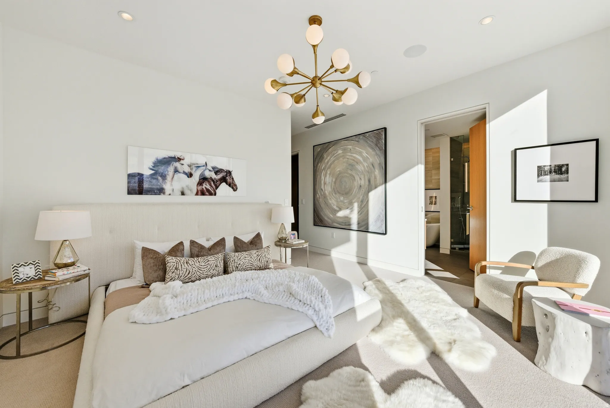 Spacious bedroom featuring recessed lighting, a modern sputnik chandelier, and neutral wall tones