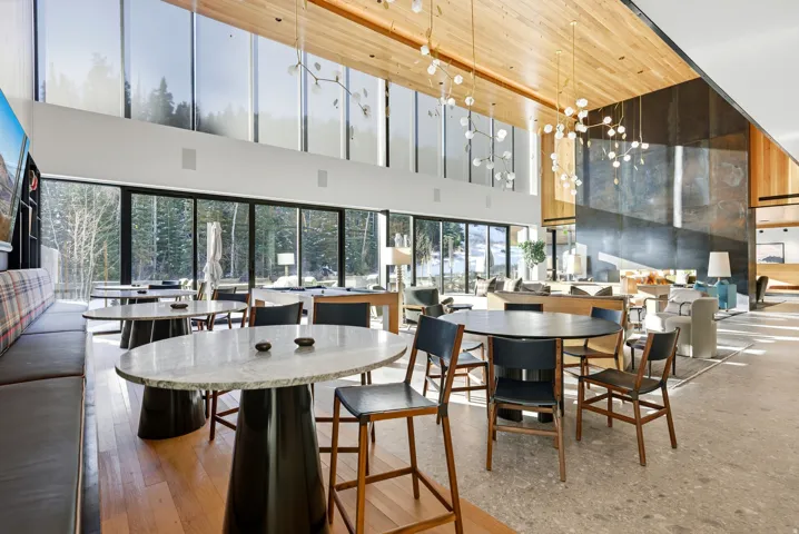 Expansive room with high ceilings and floor-to-ceiling windows