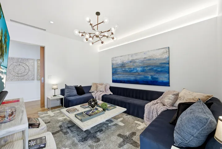 Living room featuring hanging lights and wood finished floors