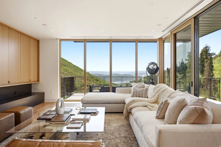 Expansive window walls providing panoramic mountain and lake scenery