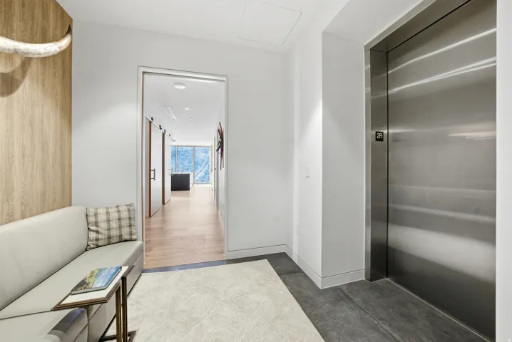 Hall with elevator and baseboards