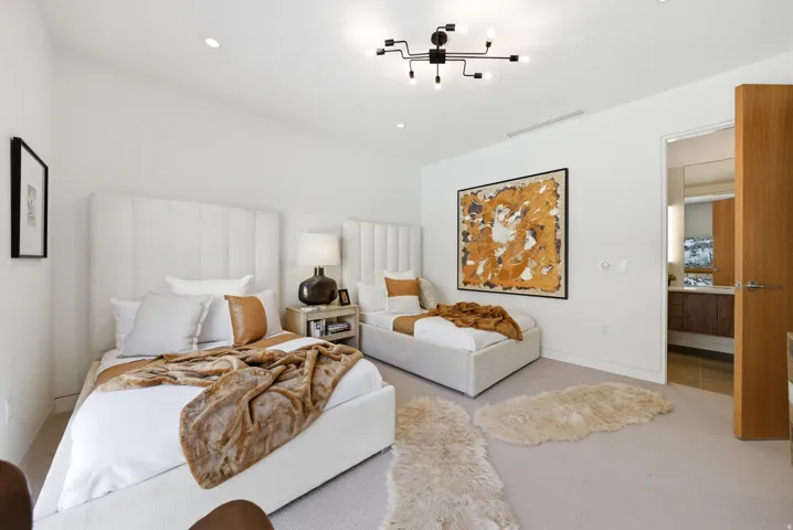 Spacious room featuring light-colored carpeting, recessed lighting, and a contemporary black ceiling fixture