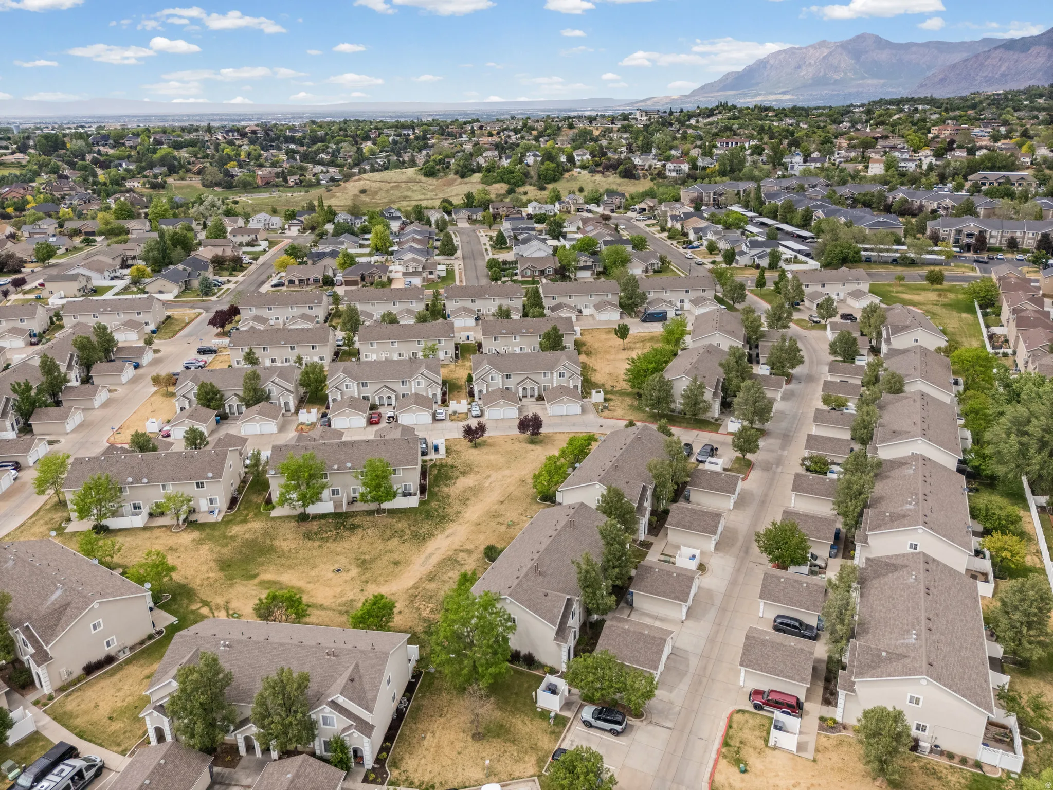 Aerial perspective showcasing a residential community with numerous townhomes