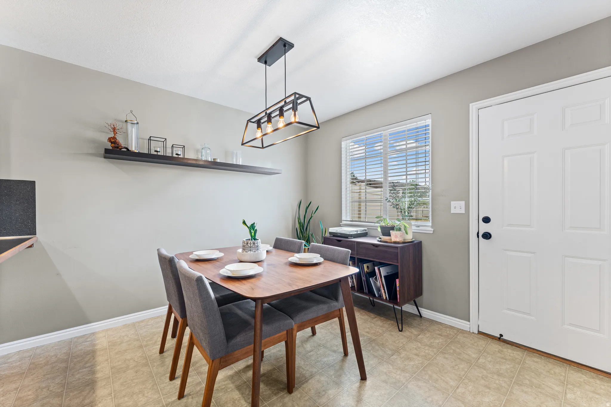 Dining area featuring light-toned tile flooring and neutral wall tones